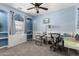 Bright bedroom featuring a ceiling fan, built-in shelves, and a sewing machine station at 30704 N 138Th Ave, Peoria, AZ 85383