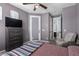 Serene bedroom with a mounted TV, outdoor access and an adjoined bathroom for a spa-like experience at 30704 N 138Th Ave, Peoria, AZ 85383