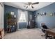 Stylish bedroom with blue walls, comfortable seating and a ceiling fan for optimal comfort at 30704 N 138Th Ave, Peoria, AZ 85383