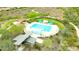 Stunning aerial view of the community pool and amenities with shade structures and native landscaping at 30704 N 138Th Ave, Peoria, AZ 85383