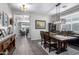 Elegant dining area with a wooden table, chandelier lighting, and access to the living room at 30704 N 138Th Ave, Peoria, AZ 85383