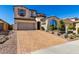 Inviting two-story home with a brick driveway, desert landscaping, and an attached two-car garage at 30704 N 138Th Ave, Peoria, AZ 85383