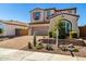 Beautiful two-story home with a desert landscape, brick driveway, and a neatly manicured front yard at 30704 N 138Th Ave, Peoria, AZ 85383