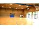 Large, indoor gymnasium featuring basketball courts and high ceilings with recessed lighting and doors to the outside at 30704 N 138Th Ave, Peoria, AZ 85383