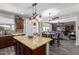 Open-concept kitchen flows into the dining and living areas, featuring a large island with seating at 30704 N 138Th Ave, Peoria, AZ 85383