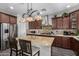 Stylish kitchen featuring a large island with seating, stainless steel appliances, and mosaic backsplash at 30704 N 138Th Ave, Peoria, AZ 85383
