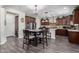 Modern kitchen with stainless steel appliances, a central island, and dark wood cabinetry at 30704 N 138Th Ave, Peoria, AZ 85383