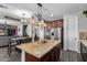 An open-concept kitchen with stainless steel appliances, pendant lighting, and a granite island at 30704 N 138Th Ave, Peoria, AZ 85383