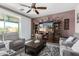 Comfortable living room with a ceiling fan, sliding glass doors, and stylish decor at 30704 N 138Th Ave, Peoria, AZ 85383