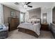 A spacious bedroom with an upholstered bed, a ceiling fan, and two nightstands at 30704 N 138Th Ave, Peoria, AZ 85383