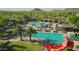Community pool featuring multiple pools, lounge chairs, shade structures, and waterslide inflatables for Gathering fun at 30704 N 138Th Ave, Peoria, AZ 85383