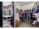 Organized walk-in closet with shelves and hanging rods, connecting to a stylish bathroom at 30704 N 138Th Ave, Peoria, AZ 85383