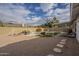 Large backyard with a pebble stone area, a pathway, and a covered patio at 4102 E Blanche Dr, Phoenix, AZ 85032