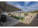 Inviting backyard oasis featuring a sparkling pool, patio cover, and artificial turf at 4102 E Blanche Dr, Phoenix, AZ 85032