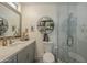 Clean bathroom with a shower/tub combo, gray vanity, and floating shelves at 4102 E Blanche Dr, Phoenix, AZ 85032