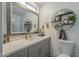 Modern bathroom with gray vanity, frameless shower, and stylish shelving at 4102 E Blanche Dr, Phoenix, AZ 85032