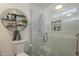 Elegant bathroom with a walk-in shower, marble tile, and floating shelves at 4102 E Blanche Dr, Phoenix, AZ 85032