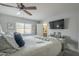 Spacious bedroom with a large bed, TV, and lots of natural light at 4102 E Blanche Dr, Phoenix, AZ 85032