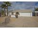 Front view of a single-story home with a large driveway and desert landscaping at 4102 E Blanche Dr, Phoenix, AZ 85032