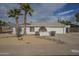 Single story home with desert landscaping, two palm trees, and a large driveway at 4102 E Blanche Dr, Phoenix, AZ 85032