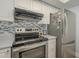 Stainless steel appliances and updated gray countertops featured in this kitchen at 4102 E Blanche Dr, Phoenix, AZ 85032