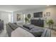 Living room with sectional sofa, large TV, and wood-look flooring at 4102 E Blanche Dr, Phoenix, AZ 85032