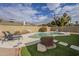 Relaxing kidney-shaped pool surrounded by artificial turf and a spacious patio at 4102 E Blanche Dr, Phoenix, AZ 85032