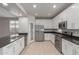 Modern kitchen with white cabinets, granite countertops, and stainless steel appliances at 4124 W Palace Station Rd, New River, AZ 85087