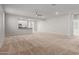 Spacious living room with neutral carpeting and a ceiling fan at 4124 W Palace Station Rd, New River, AZ 85087