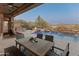 Inviting backyard with a sparkling pool, fire pit, and patio furniture at 41717 N Harbour Town Way, Anthem, AZ 85086