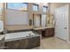 Spa-like bathroom featuring a large soaking tub and double vanity at 41717 N Harbour Town Way, Anthem, AZ 85086