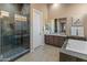 Elegant bathroom with soaking tub, walk-in shower, and dual sinks at 41717 N Harbour Town Way, Anthem, AZ 85086