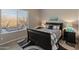 Cozy bedroom with a queen-size bed and access to a private patio at 41717 N Harbour Town Way, Anthem, AZ 85086