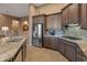 Island kitchen with stainless steel appliances and granite countertops at 41717 N Harbour Town Way, Anthem, AZ 85086