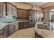 Spacious kitchen with granite countertops and dark wood cabinets at 41717 N Harbour Town Way, Anthem, AZ 85086
