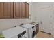 Laundry room with washer, dryer, and ample cabinet space at 41717 N Harbour Town Way, Anthem, AZ 85086