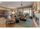 Spacious living room with fireplace and large windows offering scenic views at 41717 N Harbour Town Way, Anthem, AZ 85086