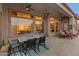 Covered patio with seating area and view into the home's interior at 41717 N Harbour Town Way, Anthem, AZ 85086