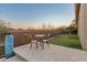 Small patio with table and chairs next to putting green at 41717 N Harbour Town Way, Anthem, AZ 85086