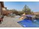 This backyard features a beautiful pool, spa, and fire pit at 41717 N Harbour Town Way, Anthem, AZ 85086