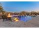 Luxury backyard oasis with a sparkling pool, spa, and fire pit at 41717 N Harbour Town Way, Anthem, AZ 85086