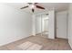 Spacious bedroom with mirrored closet doors and ceiling fan at 43249 W Jeremy St, Maricopa, AZ 85138