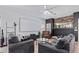 Living room featuring a large screen, comfy seating, and a fireplace at 44783 W Alamendras St, Maricopa, AZ 85139