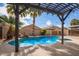 Inviting backyard pool with pergola and landscaping at 44783 W Alamendras St, Maricopa, AZ 85139