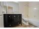 Clean bathroom with dark vanity, toilet, and bathtub at 4714 E Paso Trl, Phoenix, AZ 85050