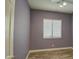 Simple bedroom with wood-look floors and a window with blinds at 4714 E Paso Trl, Phoenix, AZ 85050
