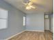 Spacious bedroom with light blue walls and wood-look flooring at 4714 E Paso Trl, Phoenix, AZ 85050