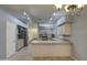 Open kitchen with island and stainless steel appliances at 4714 E Paso Trl, Phoenix, AZ 85050