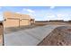 Home exterior with a long concrete driveway at 4950 Black Mountain Rd, Wickenburg, AZ 85390