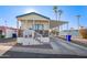 Single-wide manufactured home with carport, steps, and covered porch at 5201 W Camelback Rd # F316, Phoenix, AZ 85031
